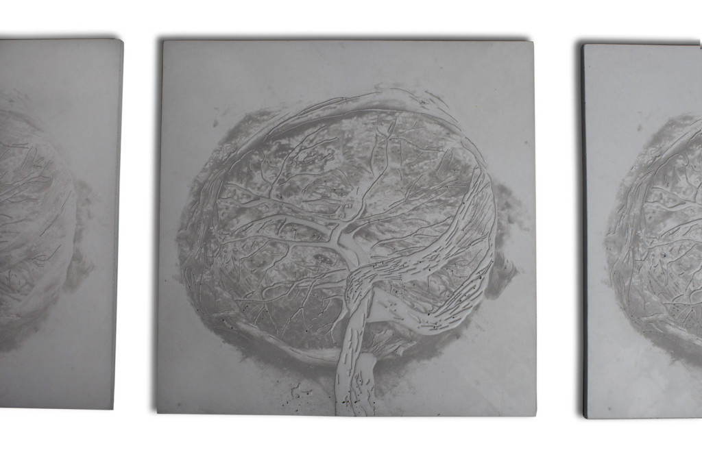 Close-up view of 1 of 7 contemporary art wall pieces of square concrete with different reliefs and variance of the image of feminity.