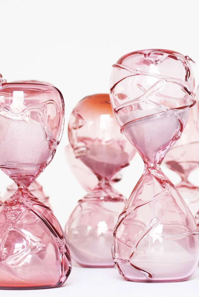 Close&ndash;up image of pink hand blown glass sculptures of hourglasses to represent the temporary nature of life.