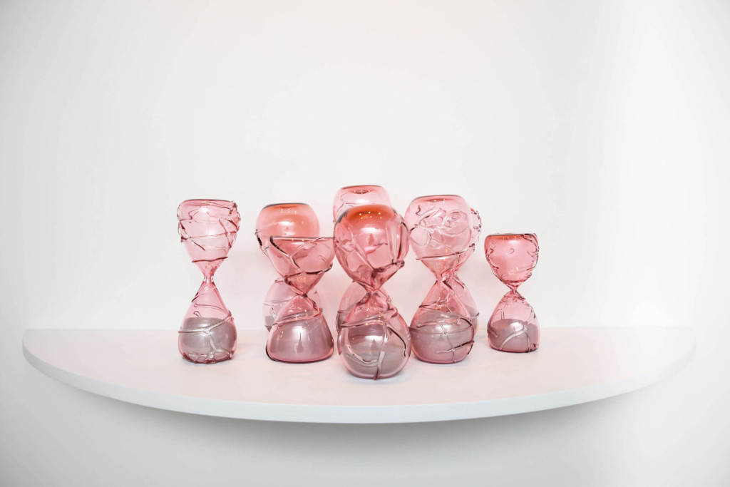 Hourglass sculptures of pink hand blown glasses to represent the temporary nature of life.
