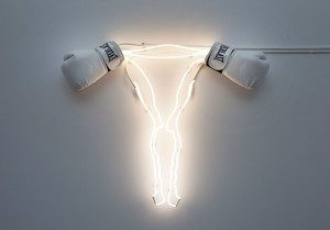 Neon shaped like uterus with boxing glove ovaries as art by Zoe Buckman