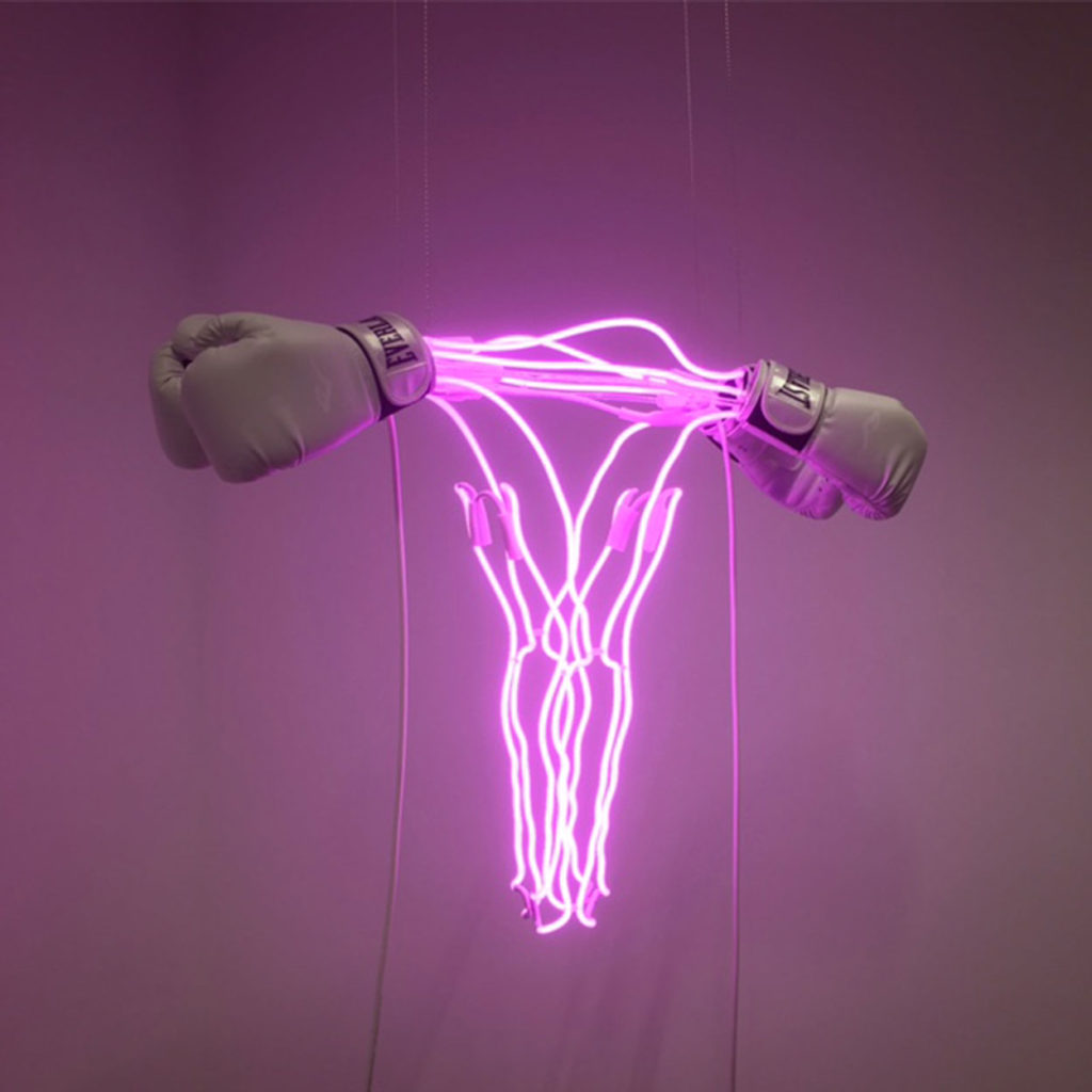 Pink neon uterus and boxing sculpture by feminist artist Zoe Buckman