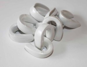 Pearl white powder coated boxing mouth guards as feminist sculpture